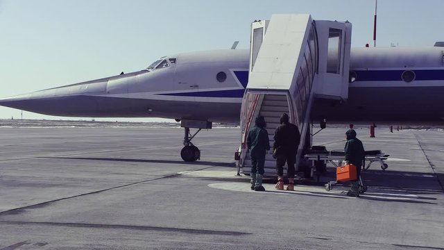People in suits approach the ramp