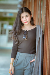Portrait of beautiful asian young woman or thai young women in a luxury suite,woman is happily at the park on a relaxing holiday