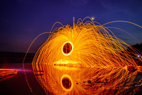 Reflection Of Wire Wool On Lake Against Sky