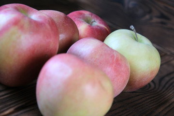 Green and red apple on dark background