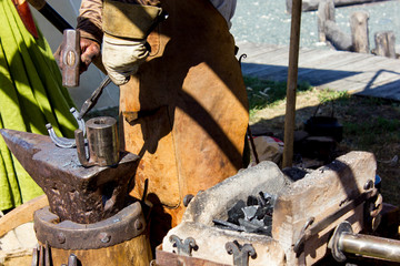 Blacksmith makes a horseshoe, a master class in medieval craft, closeup hands