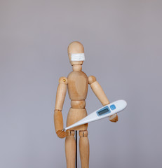 Wooden dummy in a medical mask during the epidemic period of the coronavirus virus COVID 19.