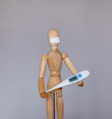 Wooden dummy in a medical mask during the epidemic period of the coronavirus virus COVID 19.