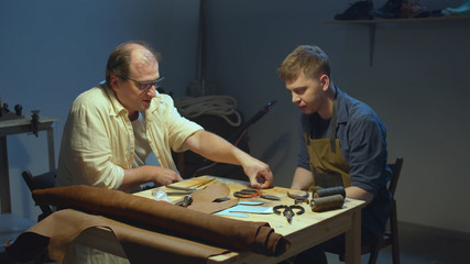 Mentor and apprentice. Shoemaker's tools