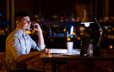 Businessman Talking On Cellphone Communicating With Distant Colleague At Workplace