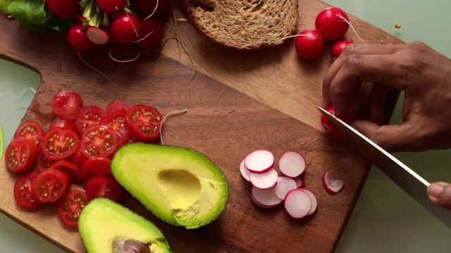 High angle view man making healthy vegan tartine sandwich
