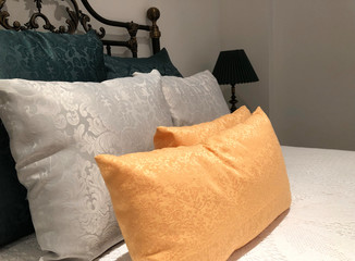 luxurious wrought iron bed with silk pillows