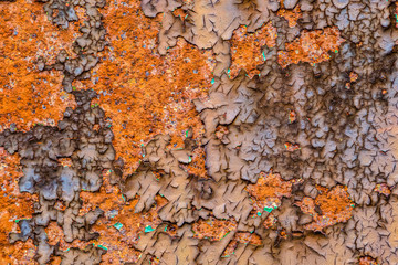 Embossed texture of the old dry cracked paint with with flashes of rust