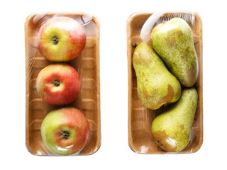 apples and pears packaged in cardboard containers wrapped in cling film for retail sale, isolated...