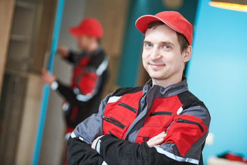 Obraz premium Furniture assembling. Professional worker portrait in front of installing cabinet at living room