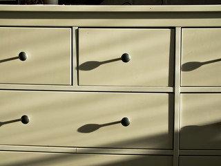 furniture handles with shadow from the sun in the evening sun. ivory furniture handles and white...