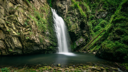 Long exposure photograph of mountain waterfall. Landscape of Miedzygorze, Sudety, Poland.