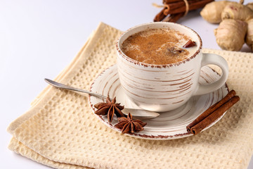 Traditional indian masala tea with spices in cup on a white background, horizontal format, Copy...