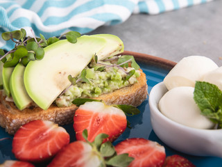 toast with guacamole, avocado, strawberries. mozzarella cheese  healthy eating