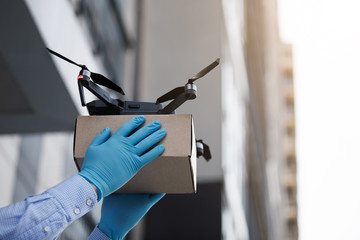 Man using drone for fast delivery of package with products