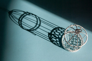 Birdcage with hard shadows. Symbol of imprisonment, bondage