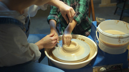 Mom teaches her son pottery. New quarantined hobbies