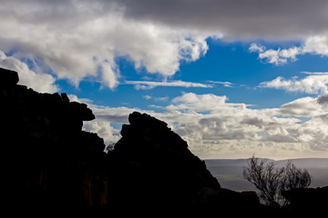 Rocks silhouetted against cloudy sky