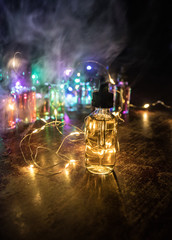 Smoke clouds and vape liquid bottles on dark background. Light effects. Useful as background or...
