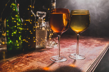Goblet of white wine on wooden table on wooden wall background