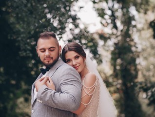 Fototapeta premium Bride and Groom at wedding Day walking Outdoors on spring nature. Bridal couple, Loving wedding couple outdoor. 