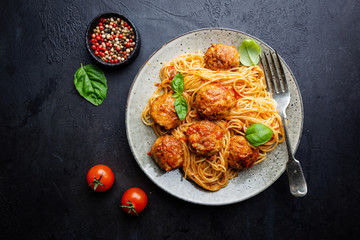 Plate of spaghetti with meatballs in tomato marinara sauce, top view