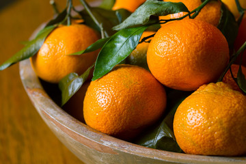 Rustic bowl of orange clementines