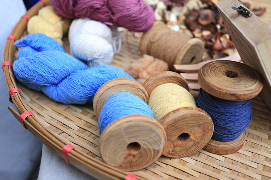 Basket With Vintage Reels With Cotton Threads Ready For The Processing On The Cotton Mill 