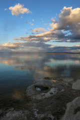 beautiful view of the  lake with the reflection of the sky in it 