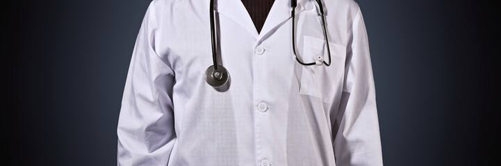 Close up of a doctor with stethoscope Banner panoramic. Medical professional preventive gear