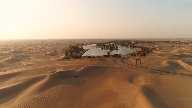 Artificial lakes in Dubai desert. United Arab Emirates nature. Love lake. Sunset aerial view. Expo2020 concept