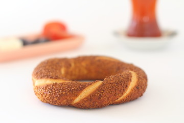 Turkish bagel, simit, tomatoes & Turkish tea on white background. 