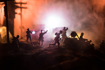 War Concept. Military silhouettes fighting scene on war fog sky background, World War Soldiers Silhouette Below Cloudy Skyline At night.
