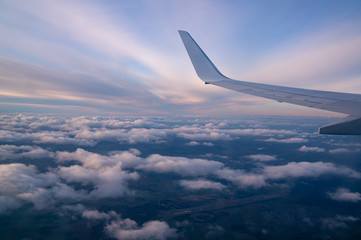 Fototapeta premium clouds under the wing of an airplane