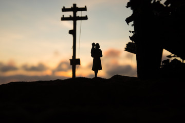 Two homeless little girl walking in destroyed city, soldiers and helicopters and tanks are still...