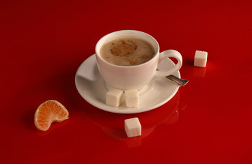A white Cup of coffee on a glossy red table