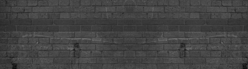 Dark black anthracite damaged rustic brick wall texture banner panorama 
