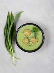 Vegan soup-puree greens with meatballs in a bowl on a light background top view