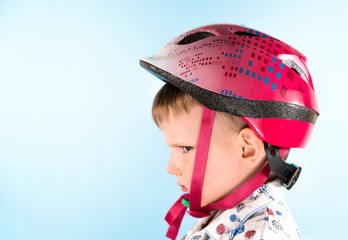 .displeased boy with a protective helmet. Safety, child.