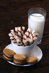 Cookies on the plate and mug on dark and milk