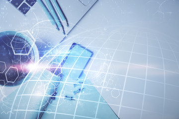 Double exposure of map hologram drawing over study table background with computer. Concept of international network. Top view.