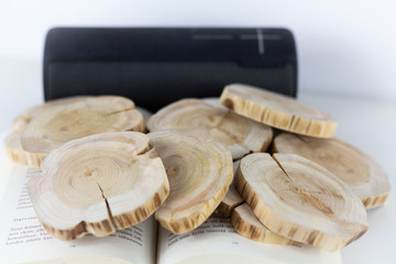 Black speaker, book and wooden coins on top