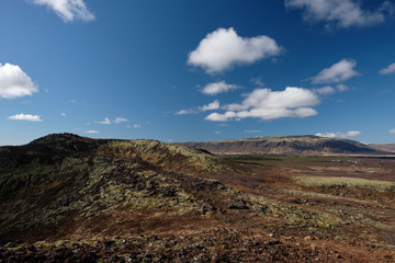 The Icelandic landscape seen from the rim at top of Kerid Volcano crater