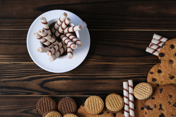 Fototapeta premium Cookies on the plate and mug on dark