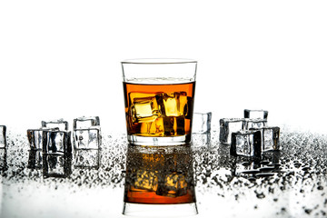 Whiskey with ice cubes.Isolated shot of whiskey.Glass of scotch and ice cubes on a white background.