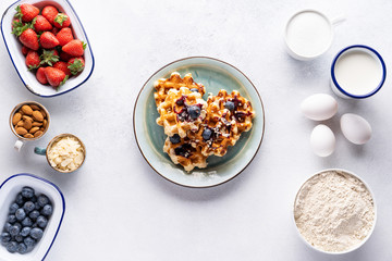 Ingredients for baking and Breakfast (eggs, flour, sugar, milk and butter) on a gray background. Concept: delicious and healthy food.