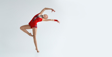 Fototapeta premium Professional dancer enjoying her performance on white studio background, empty space. Panorama