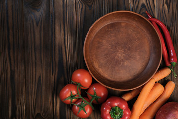 vegetables with an empty clay plate