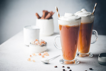Iced coffee in a tall glasses with cream poured over
