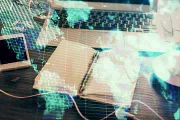 Obraz premium Double exposure of business theme drawings and desk with open notebook background. Concept of international market